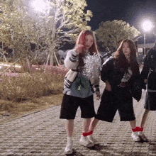 a girl with red hair is wearing a sweater that says ' fc ' on it