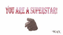 a sign that says you are a superstar with a hand pointing