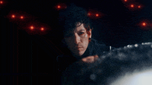 a man with red eyes and a nose ring