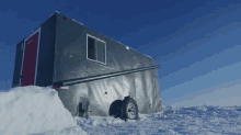 a trailer is sitting in the snow and has the number 1 on it