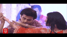 a man kissing a woman 's hand with the abp logo in the background