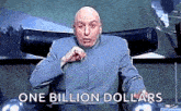 a bald man is sitting in a chair and pointing at the camera with the words `` one billion dollars '' .