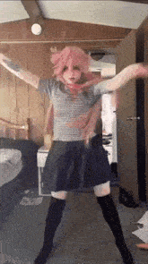 a girl with pink hair is dancing in a room with wood paneling