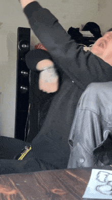 a man in a black jacket has a yellow tag on his jacket that says ' yellow ' on it