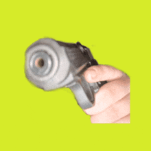 a person holding a gun with smoke coming out of the barrel