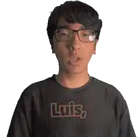 a man with glasses and a shirt that says luis on it