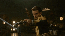 a man in a green and gold uniform holds a trumpet in his right hand