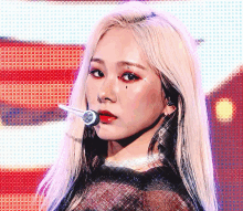 a close up of a woman 's face with a microphone in her hand