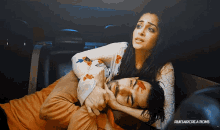 a woman laying on a man 's lap with ruksarcreations written on the bottom