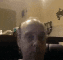 a close up of a man 's face in front of a mirror in a bathroom