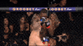 two men in a boxing ring with a sign that says loobet fun