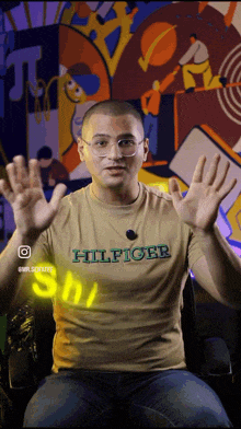a man wearing a t-shirt that says ' hilfiger ' on the front