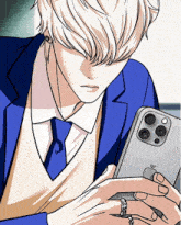 a man wearing a blue suit and tie is holding an apple phone