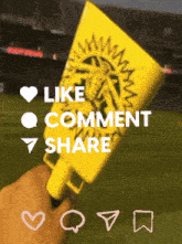a person holding a yellow fan that says like comment share on it