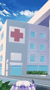 a hospital with a red cross on the side of it
