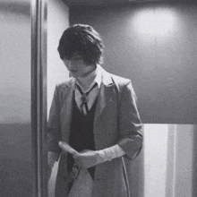 a black and white photo of a man in a suit