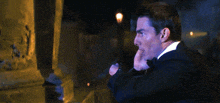 a man in a suit and tie is talking on a cell phone with the word abort written above him