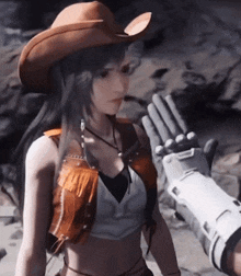 a woman in a cowboy hat is being touched by a robotic arm