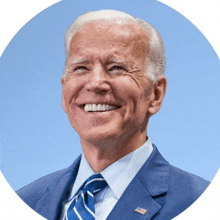 a close up of a man in a suit and tie smiling in a circle .