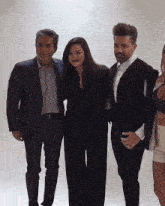 a man in a suit stands next to a woman in a bra