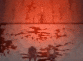 a blurred image of a bloody floor with a red light behind it .