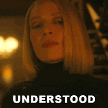 a close up of a woman 's face with the word understood written below her