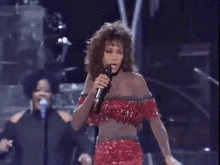 a woman is dancing on stage in front of a crowd