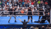 a wrestler wearing a shirt that says 420 on it stands in a wrestling ring