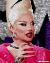 a woman in a pink dress is holding a pink object in her hand