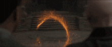 a man is running through a fire circle