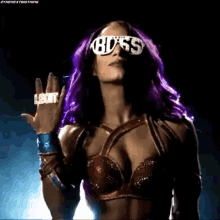 a woman with purple hair is wearing sunglasses and a ring with the word leon on it .