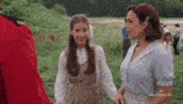 two women standing in a field with the word hallmark on the bottom left