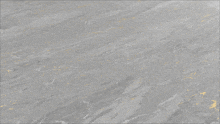 a close up of a gray marble texture with gold spots