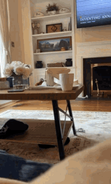 a living room with a flat screen tv that says inventing anna