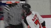 a hockey player wearing a jersey that says mckenzie on it