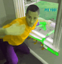 a man in a yellow shirt is holding a green water gun in front of a window with the words pee yoo written on it