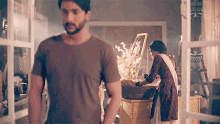 a man and woman are standing next to each other in a room .