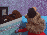 a teddy bear is playing a piano with sheet music on the screen