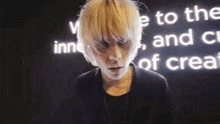 a person with white hair is standing in front of a wall that says " welcome to the inn "