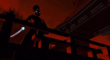 a silhouette of a person holding a sword in front of a red background