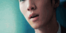 a close up of a man 's face with his mouth open and his nose visible .