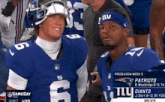 two football players for the new york giants are posing for a photo