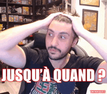 a man holding his head with the words jusqu ' a quand in red