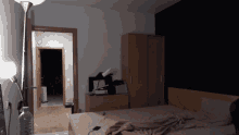a bedroom with a bed and a bottle of water on the floor
