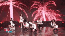 a group of women are dancing on a stage with the words simply pop on the bottom right