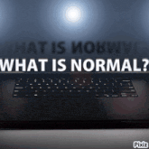a laptop with the words " what is normal " on it