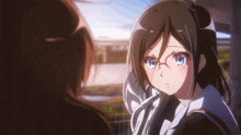 a girl wearing glasses looks at another girl