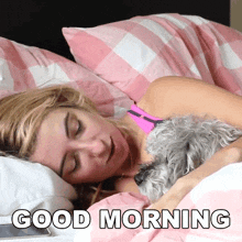 a woman is sleeping in bed with a small dog and the words good morning are on the bottom
