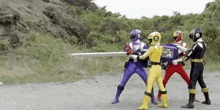 a group of power rangers are fighting each other with swords