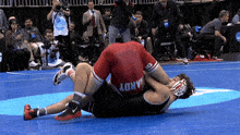 a wrestler with the name hardy on his shorts is wrestling another wrestler